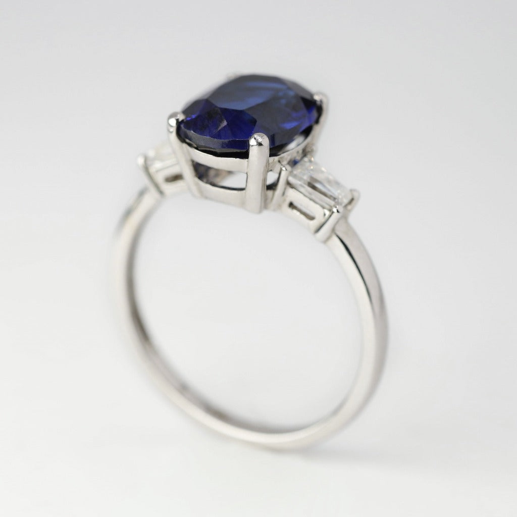 3ct- center, oval cut, blue sapphire gemstone .25ct- 1pc each side, tapered baguette