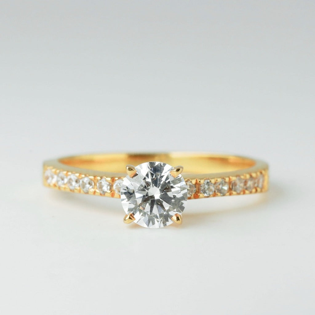 Round brilliant cut with 1ct center stone and .01ct sides stones in timeless pave setting. The stone in the photo is swiss stone by default. You can definitely upgrade your stone into moissanite or genuine diamond with GIA certification. Grams Approx: 3