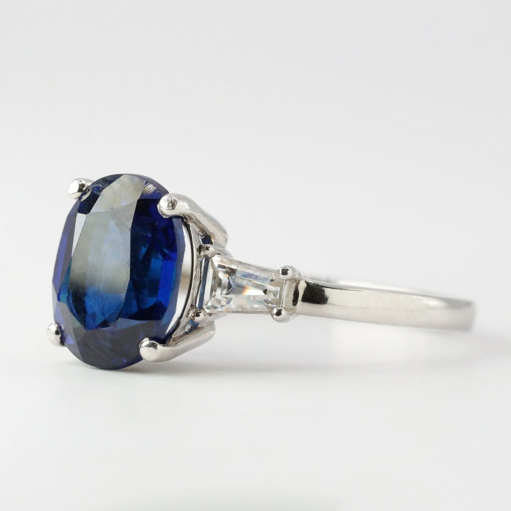 3ct- center, oval cut, blue sapphire gemstone .25ct- 1pc each side, tapered baguette
