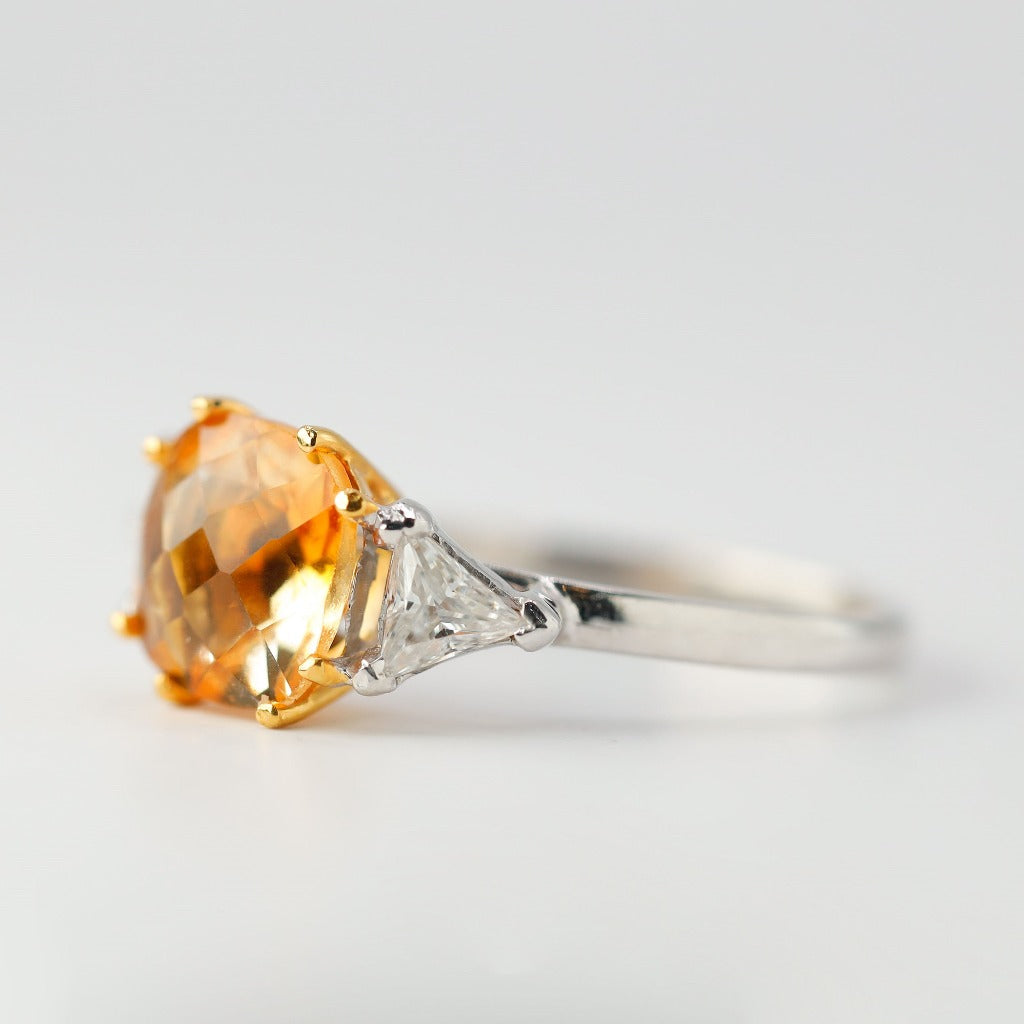2ct- center, cushion cut, orange topaz gemstone .20ct- 1pc each side (2pcs in total), trilliant cut