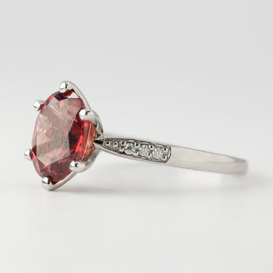 2ct- center, oval cut, garnet gemstone .01ct- 3pcs, each side